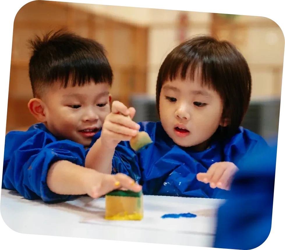 Two children painting together